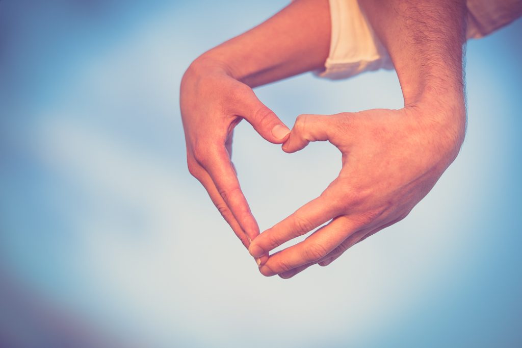 Engagement session couple making heart with their hands