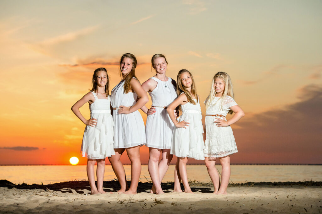Family portrait of five sisters on the beach at sunset at First Landing State Park in Virginia Beach