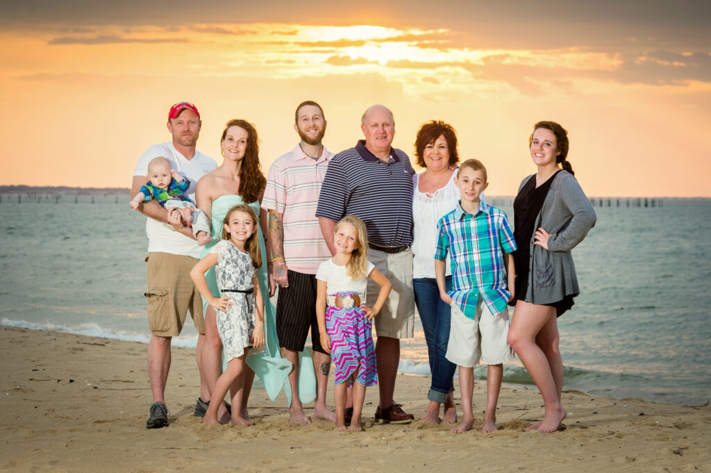 Family portrait with grandparents at sunset on the beach