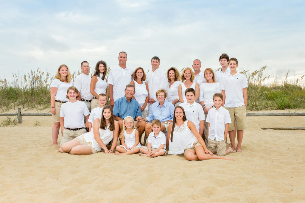 Large family portrait posed on the beach