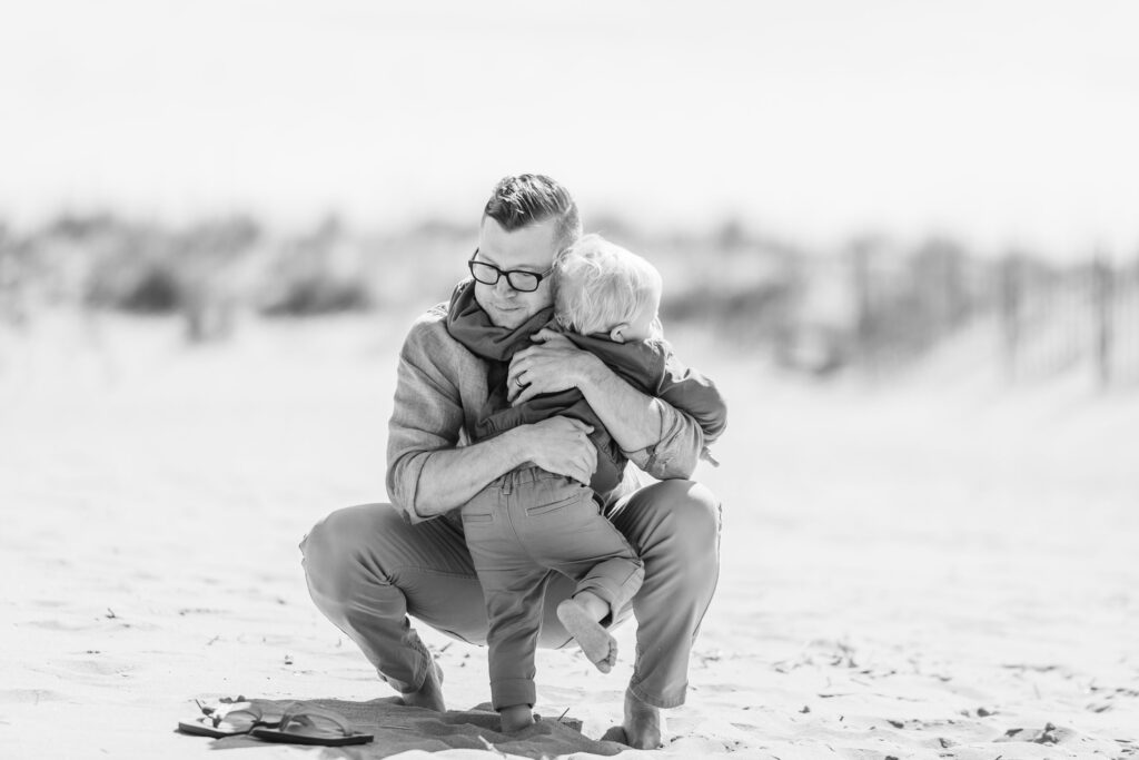 Father and son moment during the family portrait on the beach