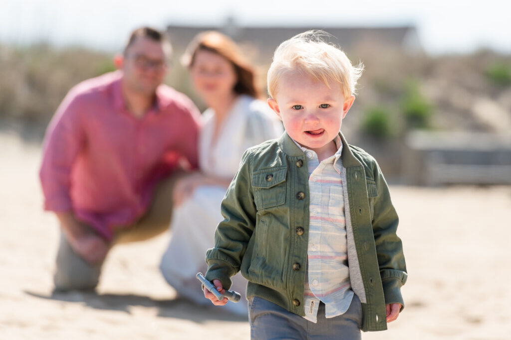 Close up of child with parents in the background