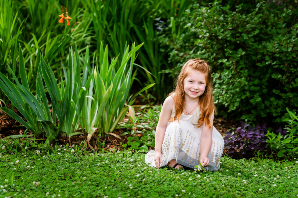 Little girl in a white dress at her family portrait at the Chesapeake Arboretum