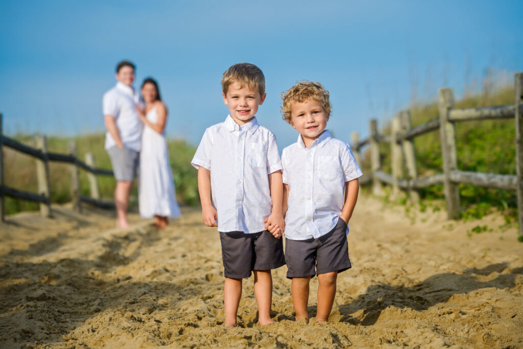 Close up of two brothers with mom and dad in the background