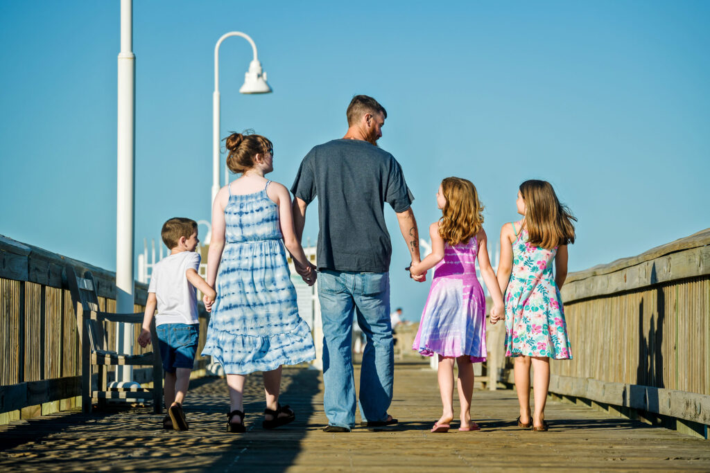 Father with his children walking on the pier at Little Island Park