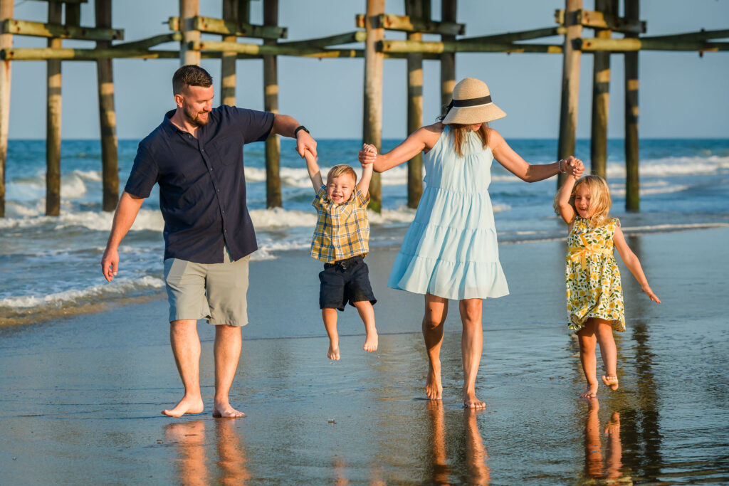 Candid moment of a family walking on the beach in Sandbridge