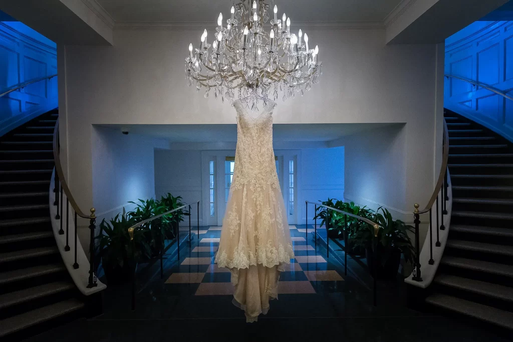 Wedding dress hanging from a chandelier at the Cavalier Hotel