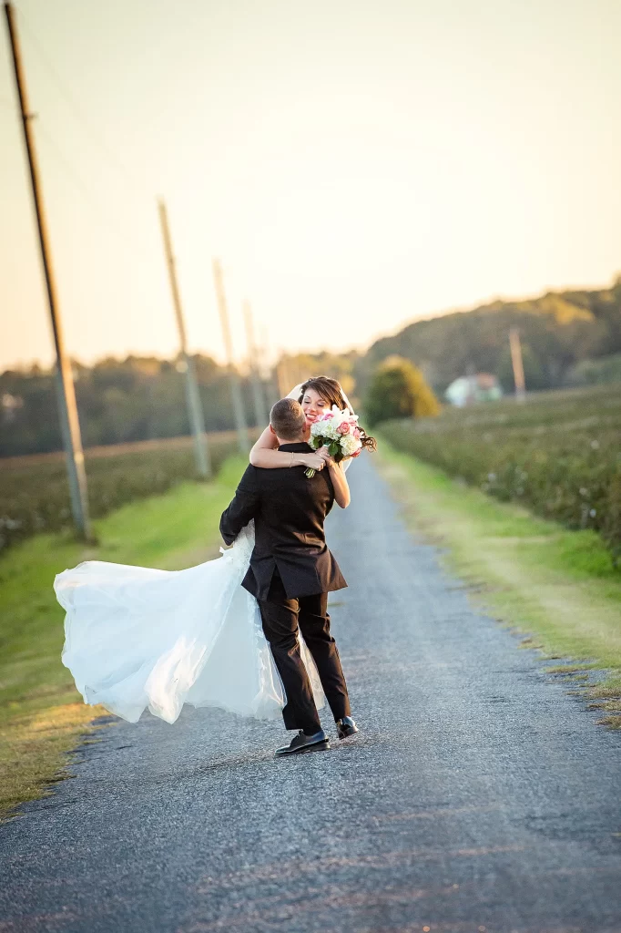 Bride and Groom embracing on a country road