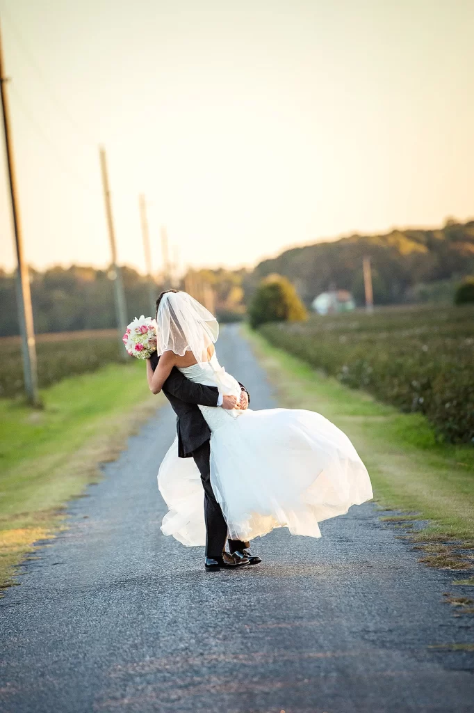 Bride and Groom embracing on a country road