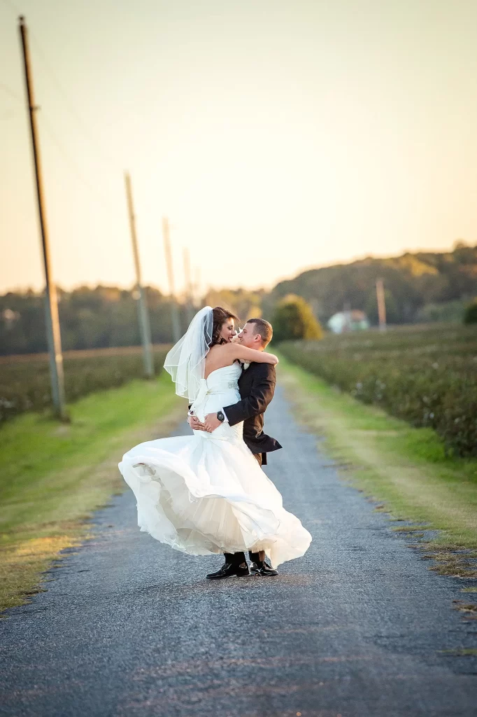 Bride and Groom embracing on a country road