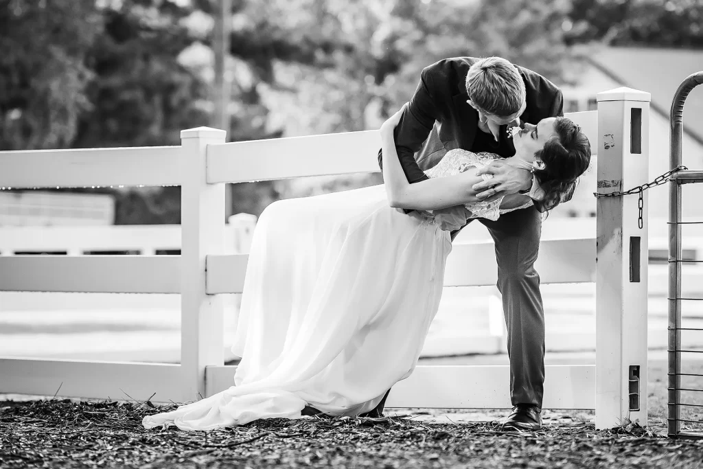 Bride and Groom dip kissing at the Hunt Club Farm
