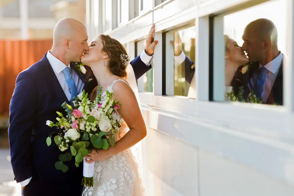 Bride and Groom kissing on the deck of the Lesner Inn