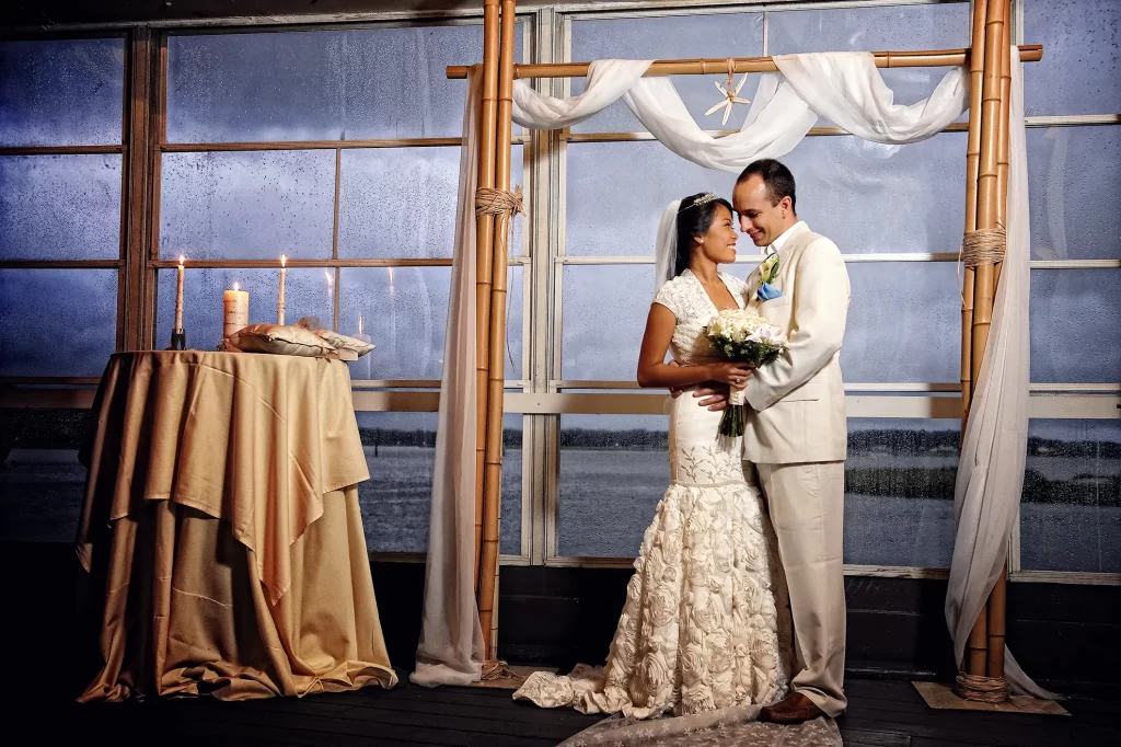 Bride and Groom at the altar with rainy backdrop at the Lesner Inn
