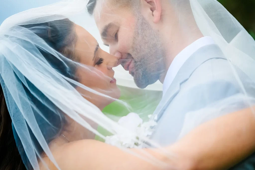 Bride and Groom embrace under the veil