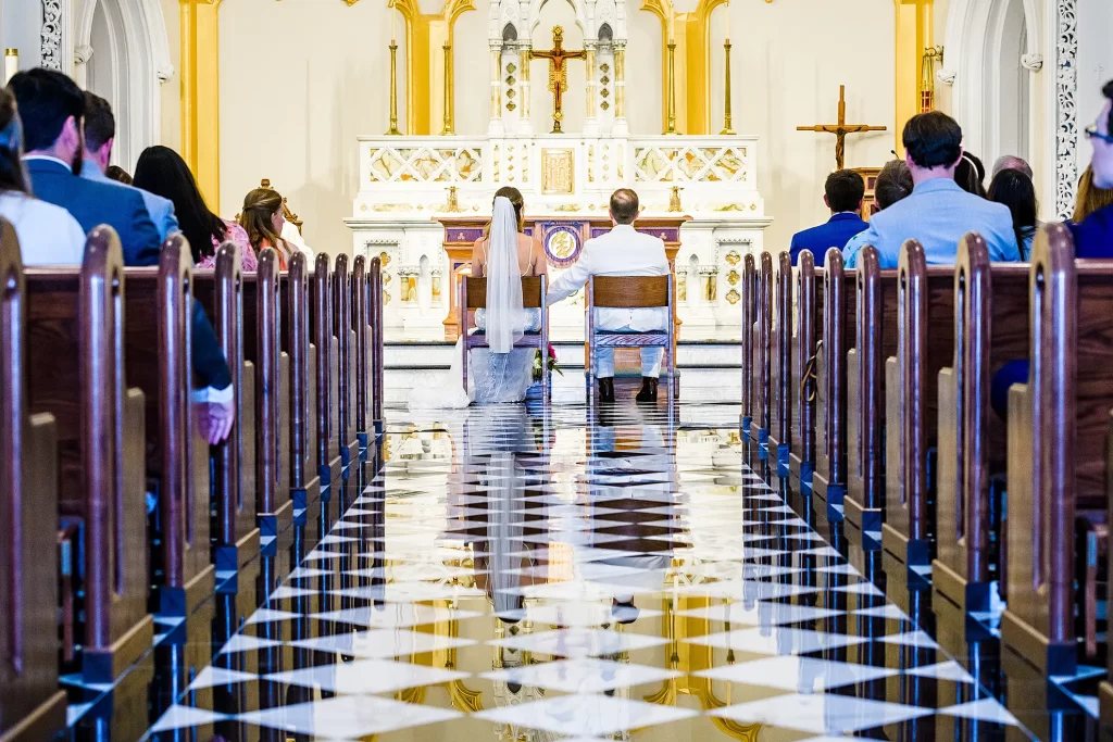 Bride and Groom sitting during ceremony at the Basilica in Norfolk, VA