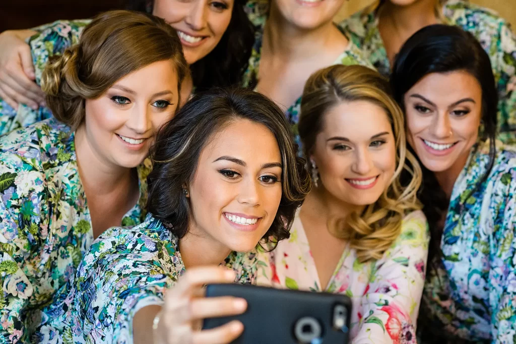Bride with bridesmaids taking selfie