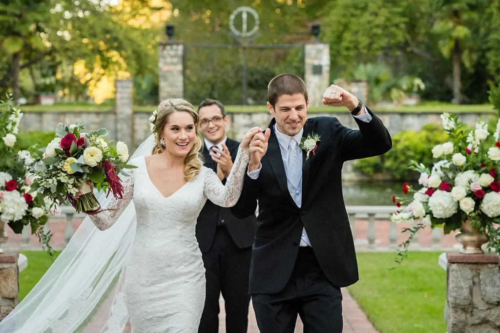 Bride and Groom exiting ceremony in excitement