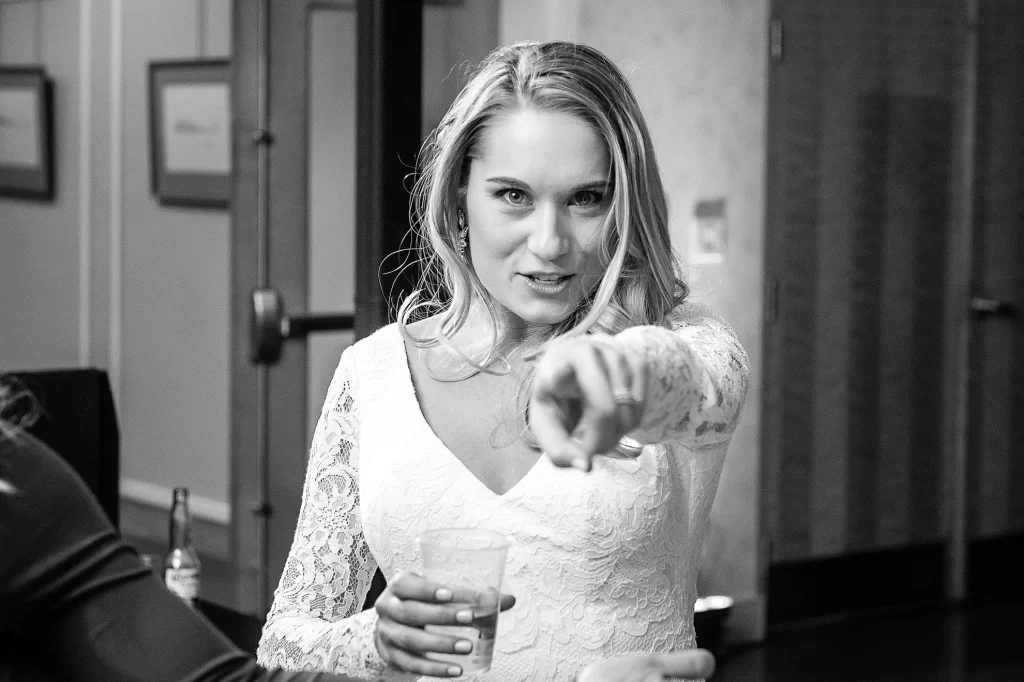 Cute bride pointing at the camera