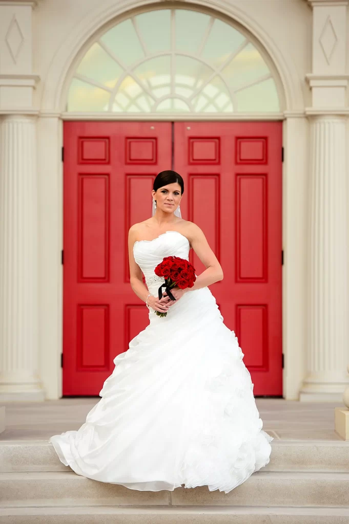 gorgeous bride in front of red door