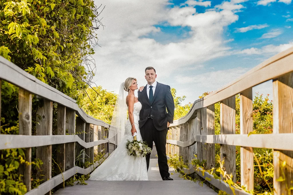 stoic bride and groom on the boardwalk